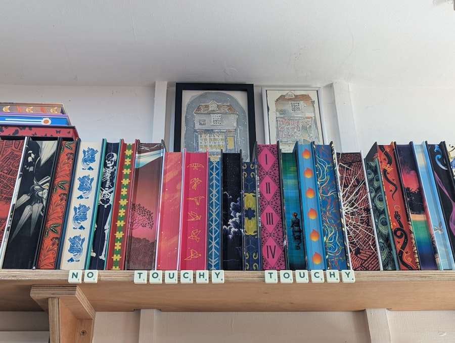 No touchy touchy sign made of scrabble pieces on the top shelf